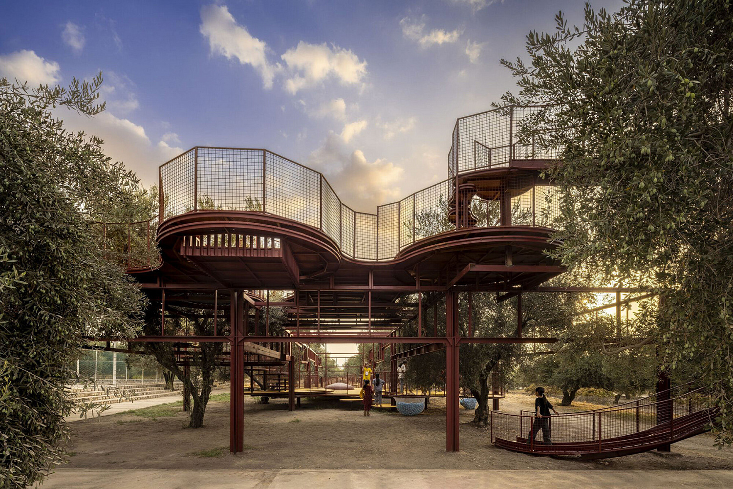 Архитектурное бюро ZAV Architects создало модульную жёлтую игровую площадку посреди оливкового сада в Иране